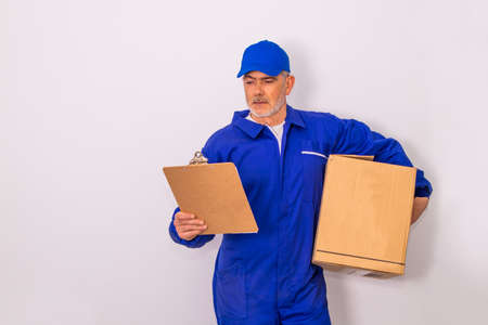 isolated man with deliveryman clothes and box or packageの写真素材
