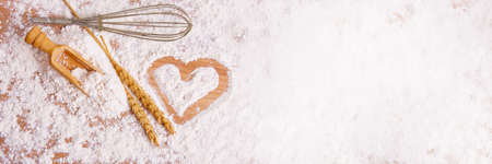 flour background with kitchen and pastry objects with drawn heart