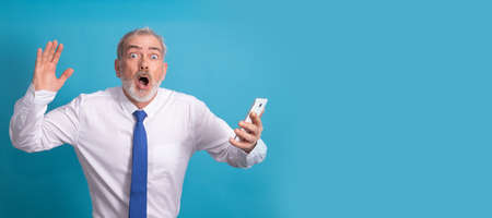 amazed isolated business adult man looking at mobile phoneの写真素材