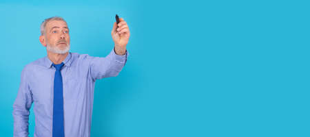 businessman with marker pen writing in backgroundの写真素材