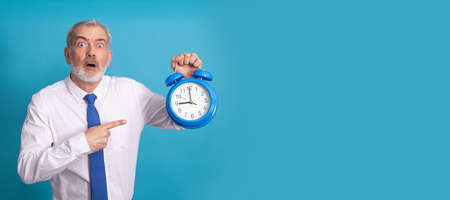 businessman with alarm clock or alarm clock isolated on backgroundの写真素材