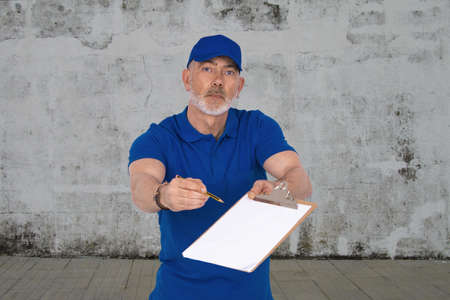 carrier or delivery man with folder to sign isolated on backgroundの写真素材