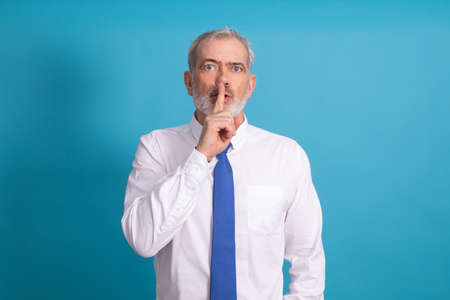 isolated businessman with expression of silence or shut upの写真素材