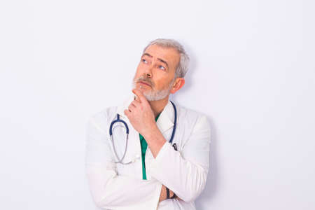 adult or senior doctor with beard and stethoscope isolated on whiteの写真素材
