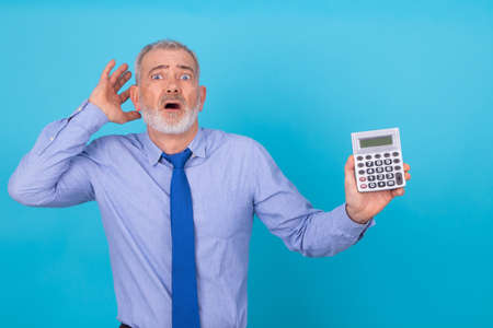 businessman with calculator stressed out and isolated on backgroundの写真素材