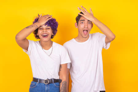 surprised couple isolated on color backgroundの写真素材