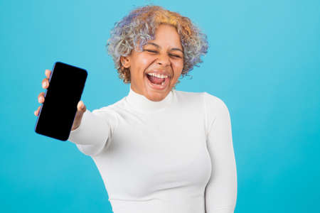 isolated african american young girl with mobile phoneの写真素材