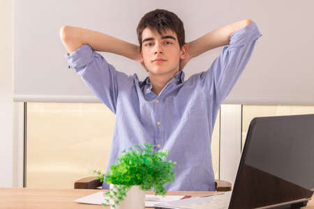 young male teenager or student at desk with computer