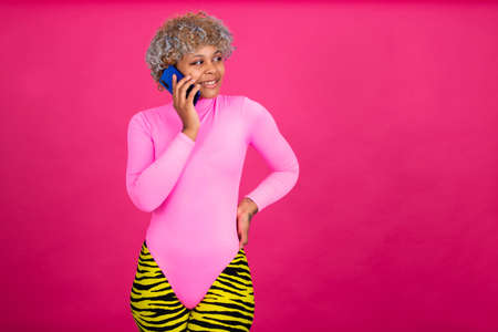 girl or woman with smartphone and sport clothes isolated on color background