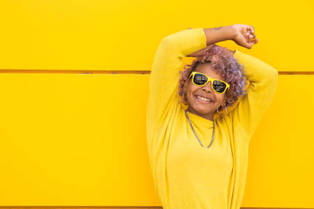 girl smiling with sunglasses on the streetの写真素材