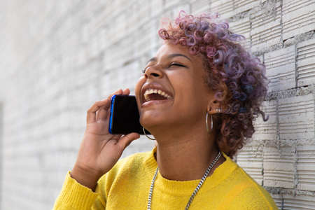girl smiling on the street with mobile phone