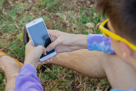 young teenager in the field with mobile phone