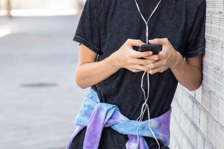 closeup of teenager with mobile phone on the street