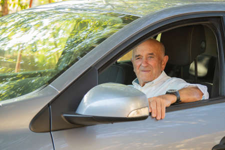 portrait of senior male driving car