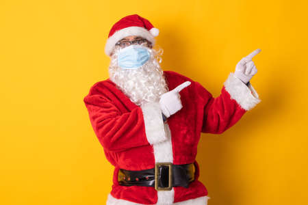 santa claus isolated on color background pointing to spaceの写真素材