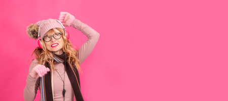 adult or senior woman dancing with headphones and winter clothesの写真素材