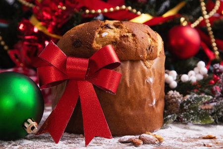 panettone with red bow and christmas decorationsの写真素材