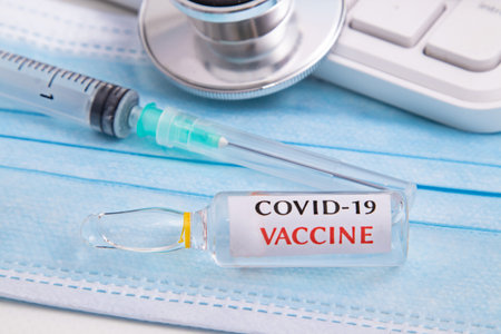 coronavirus vaccine vial in healthcare medical backgroundの写真素材