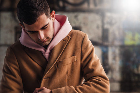 young adult man in coat on the city street