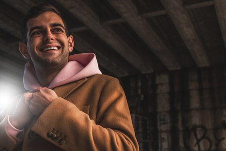 young man in coat on the streetの写真素材