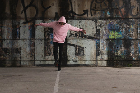 urban casual young man dancing in the city streetの写真素材