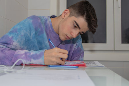 student writing on study tableの写真素材