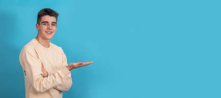 young teenager smiling isolated pointingの写真素材