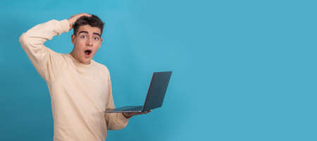 isolated surprised teenager or student with laptopの写真素材