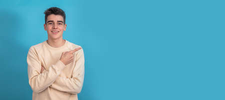 smiling teen boy pointing isolated