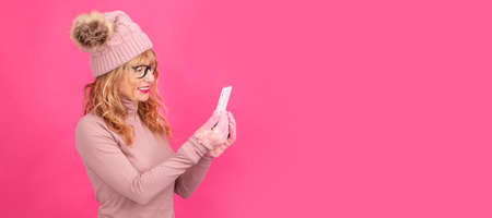 woman with mobile phone isolated on color backgroundの写真素材