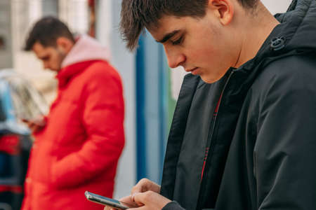 young people on the street with mobile phone