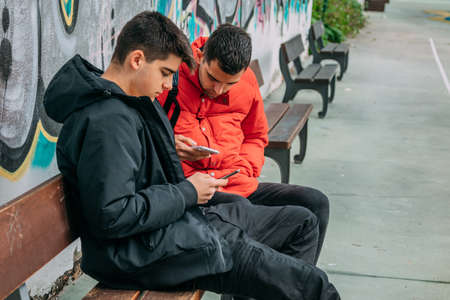 young friends with mobile phone