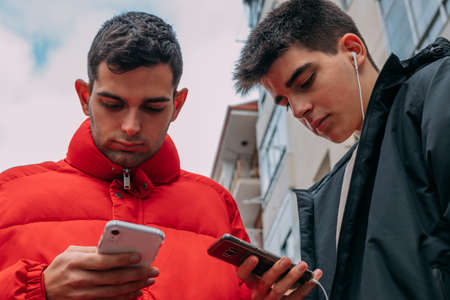 young people with mobile phone in the cityの写真素材