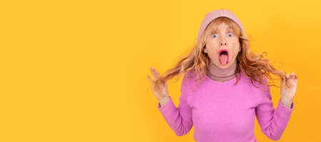 portrait of amazed adult woman clutching hairの写真素材