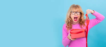 surprised adult woman with gift box isolated