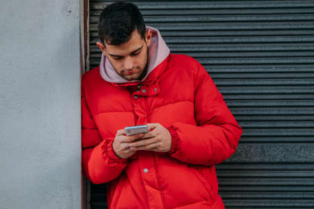 young man with mobile phone in the cityの写真素材