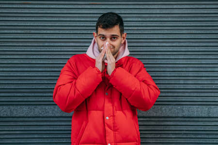 cold man in warm clothes on the streetの写真素材