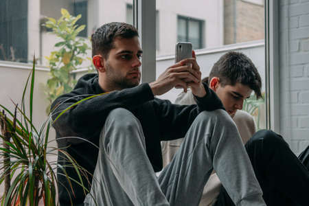 friends at home online with mobile phones