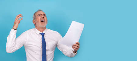 furious businessman with papers isolatedの写真素材