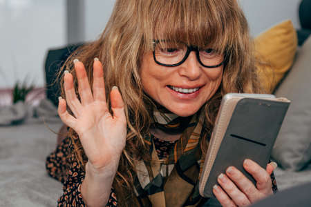 woman at home talking on the mobile phone on video