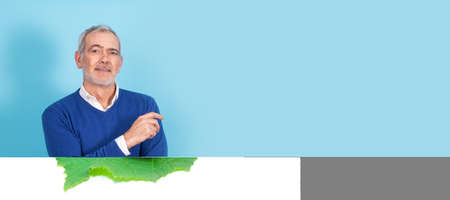 half-length portrait of man in sweater and shirt with beard and gray hairの写真素材