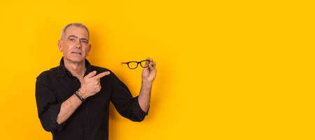 Isolated adult man pointing glasses isolated on backgroundの写真素材