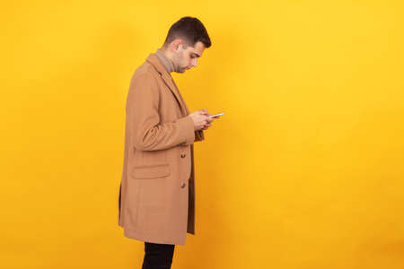 young man with mobile phone isolated on background
