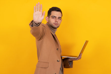 young man with laptop isolated on backgroundの写真素材