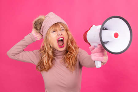 woman with megaphone isolated on color backgroundの写真素材