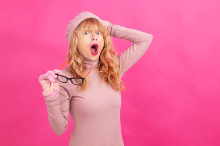 adult woman with glasses and warm clothes isolated on backgroundの写真素材