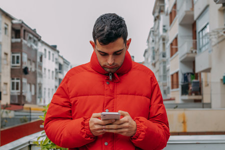 young man with mobile phone outdoors in the cityの写真素材