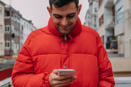 casual young man with mobile phone in the city