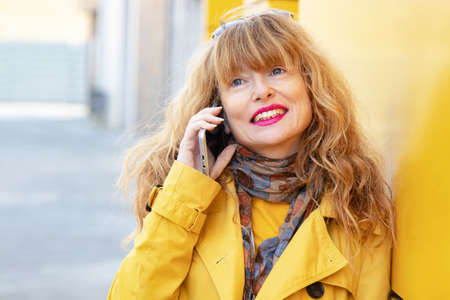 attractive woman talking on mobile phone in the street