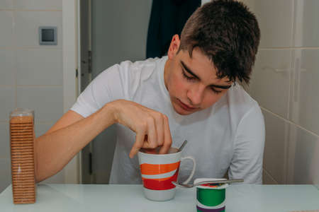 teenage boy having breakfast at home